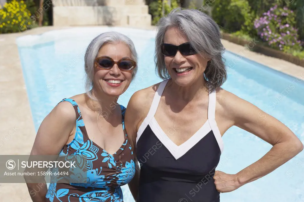 Friends at poolside in bathing suits and sunglasses