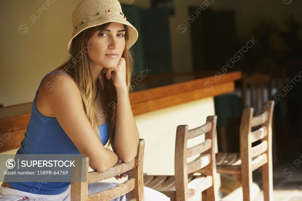 Woman wearing straw hat in bar
