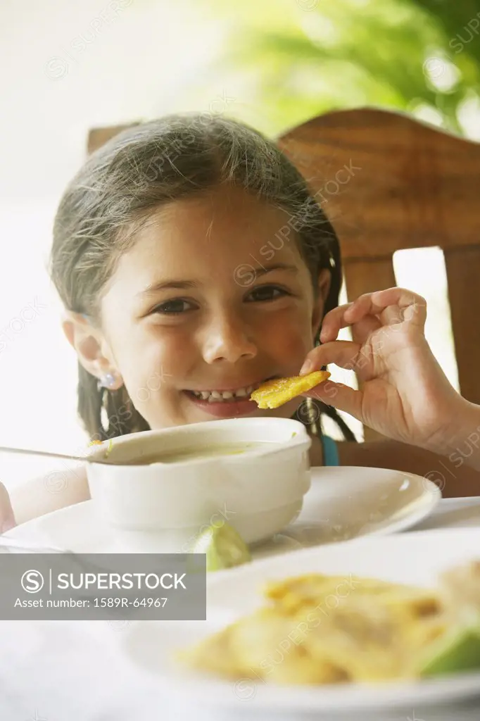 Girl eating soup for lunch