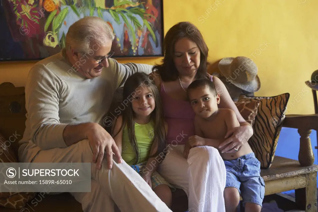 Hispanic grandparents sitting with grandchildren