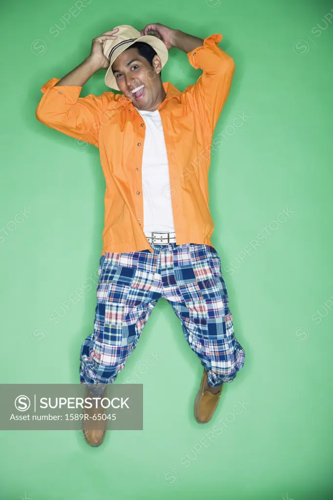 Hispanic man jumping in mid-air