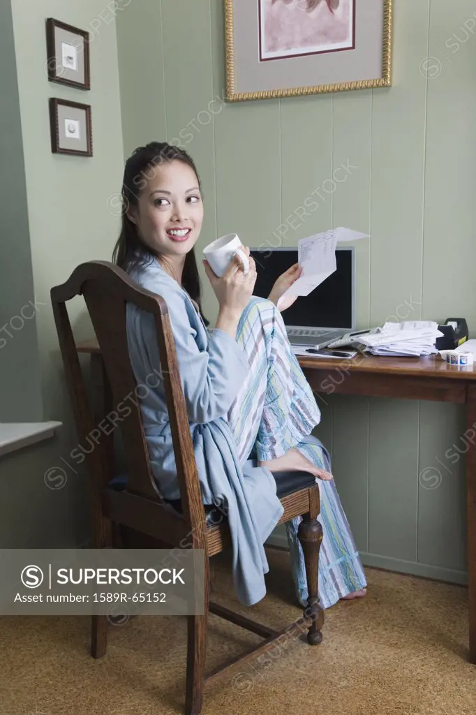 Woman sorting bills in morning