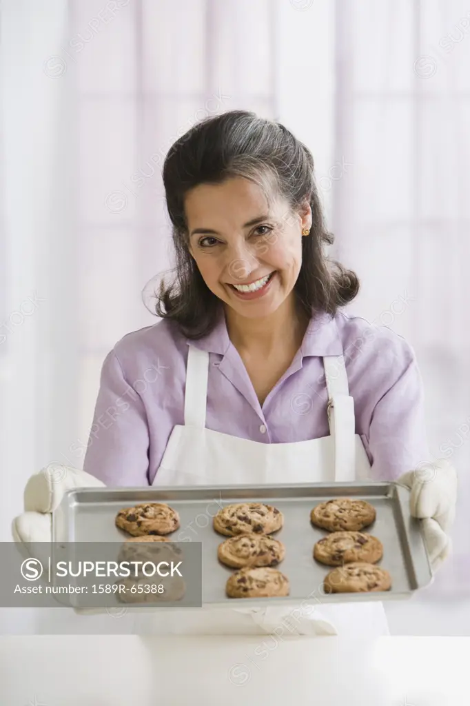 Hispanic woman baking cookies