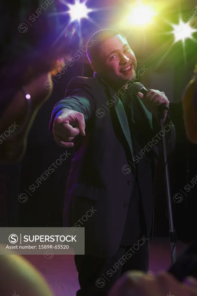 Hispanic man singing in nightclub