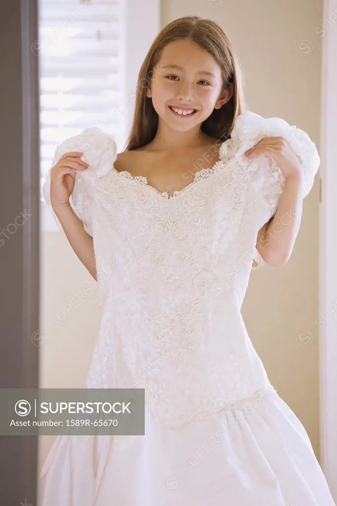 Asian girl trying on wedding dress