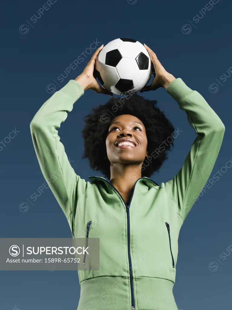 African woman holding soccer ball