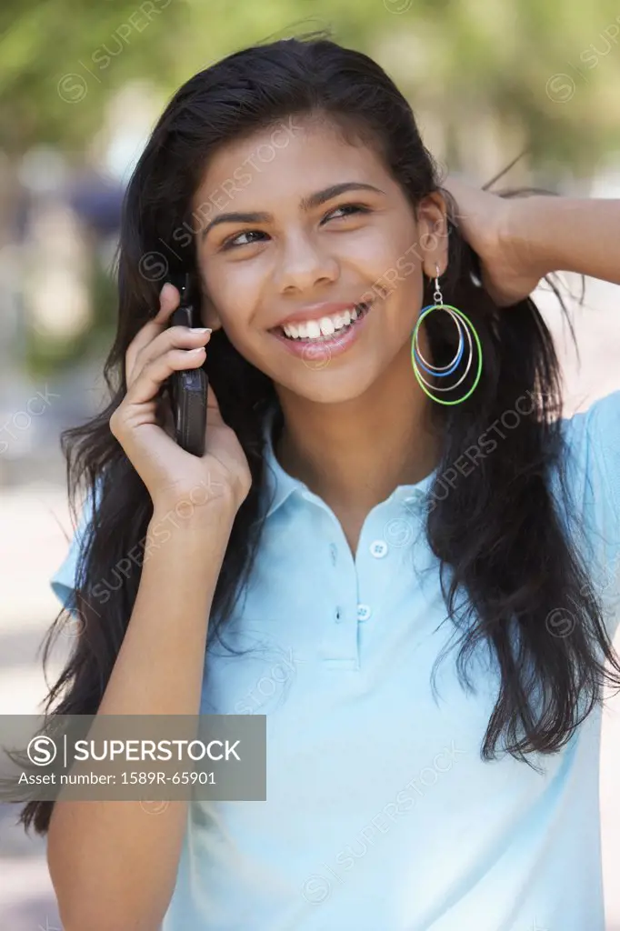 Hispanic teenager talking on cell phone