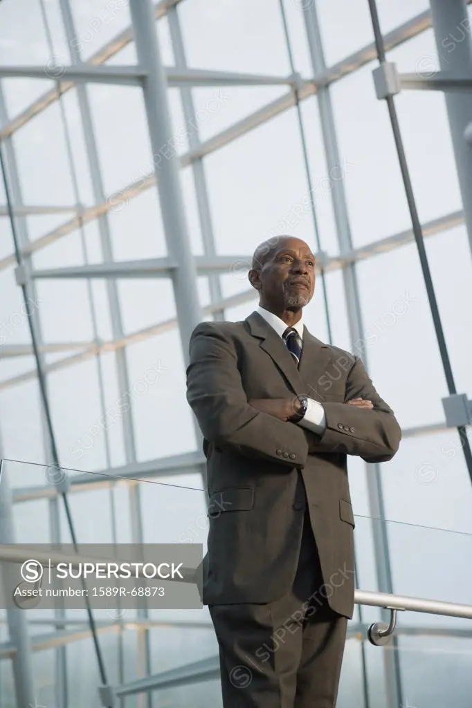 African businessman standing with arms crossed