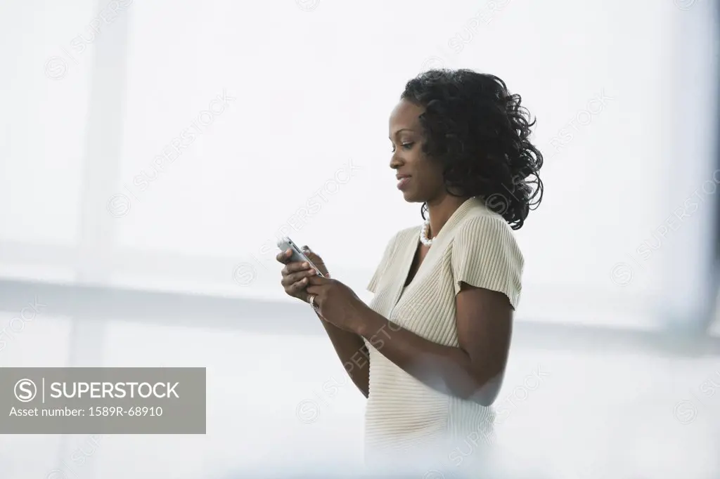 African businesswoman using cell phone