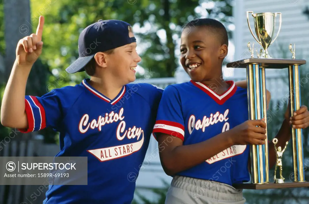 Two boys with baseball trophy