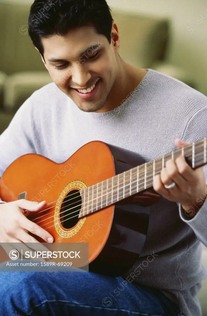 Hispanic man playing guitar