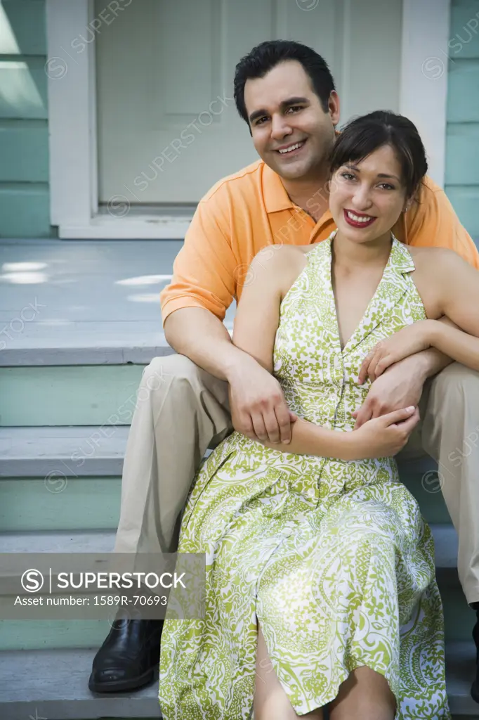 Portrait of Hispanic couple on porch steps