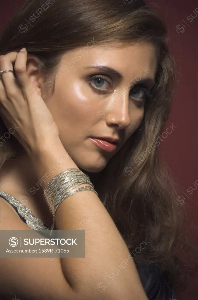 Close up of Hispanic woman with hand in hair