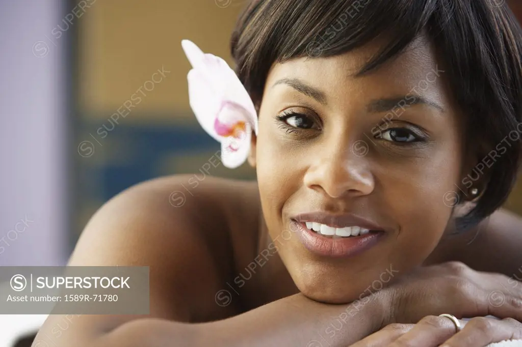 Portrait of African woman with flower in hair