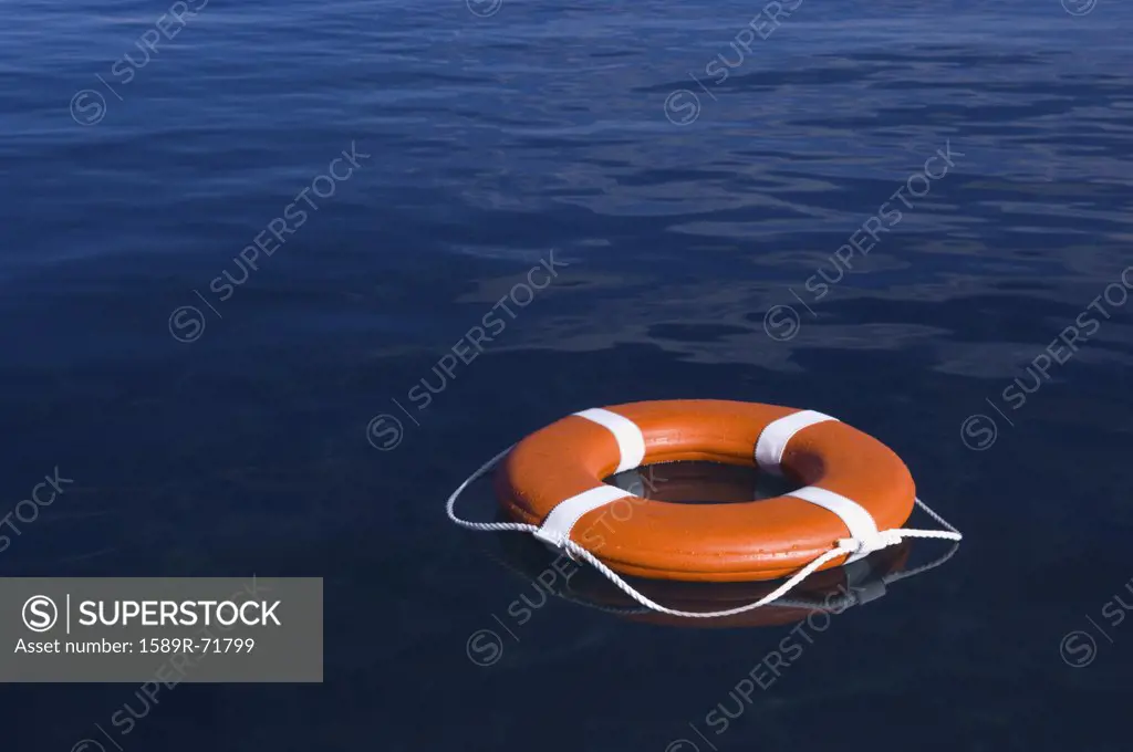 Round life preserver floating in water