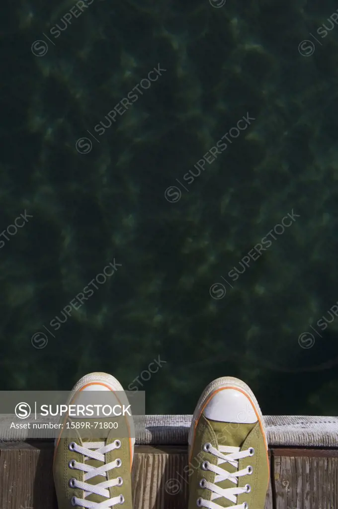 Sneakers on dock over water