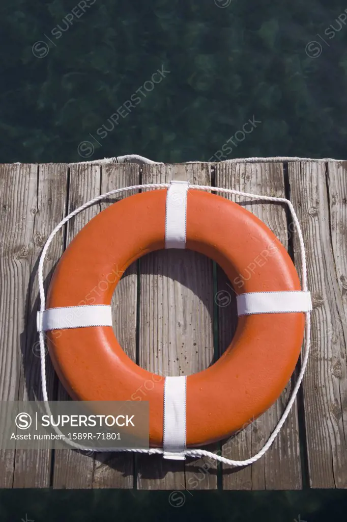 Round life preserver on wooden dock