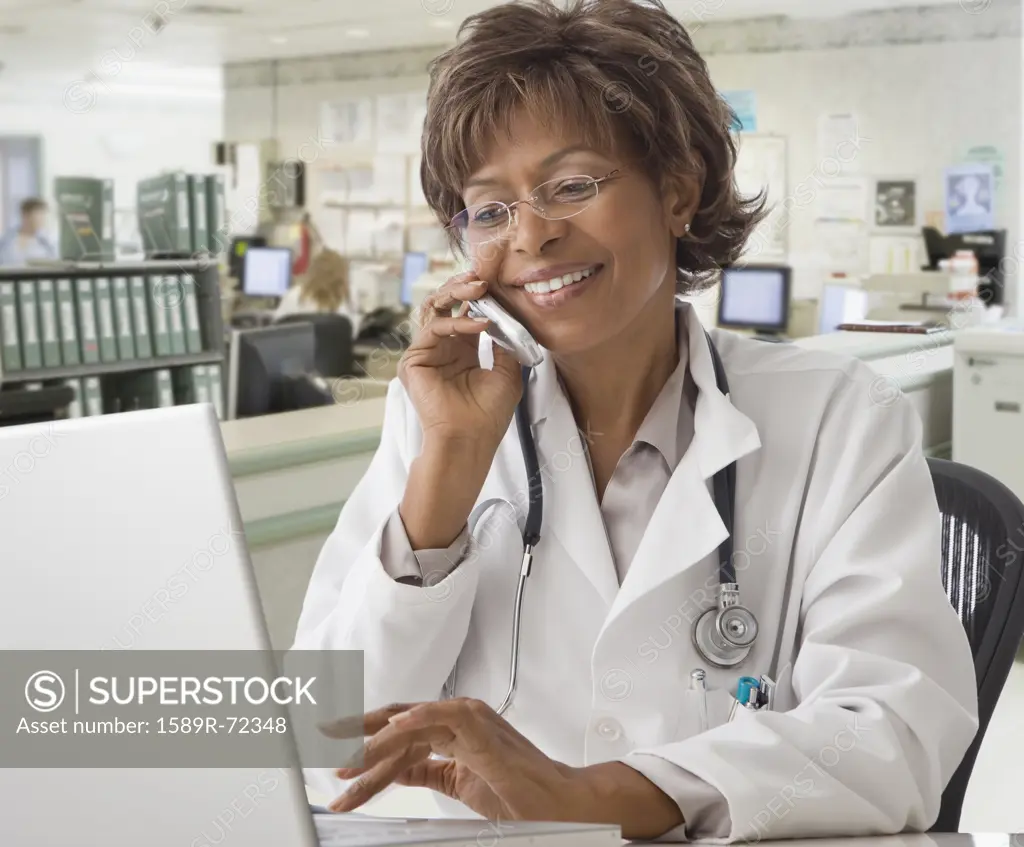 African American female doctor talking on cell phone