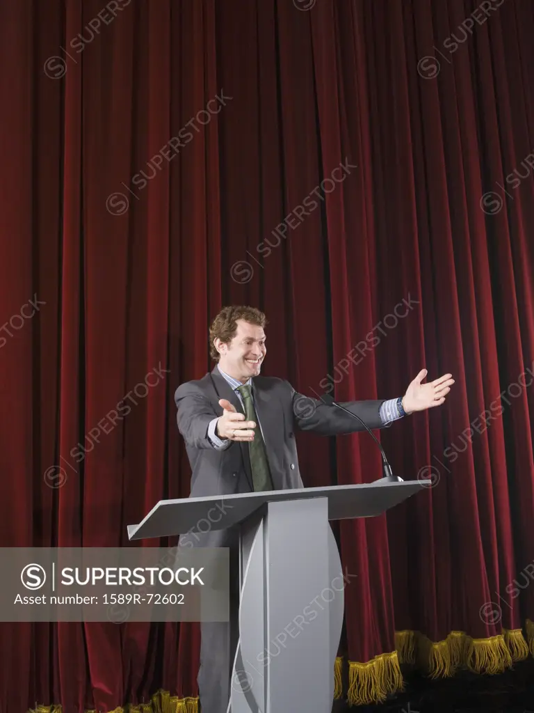 Businessman behind podium on stage