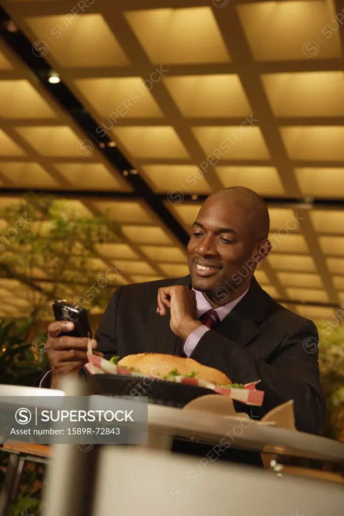 African businessman looking at cell phone