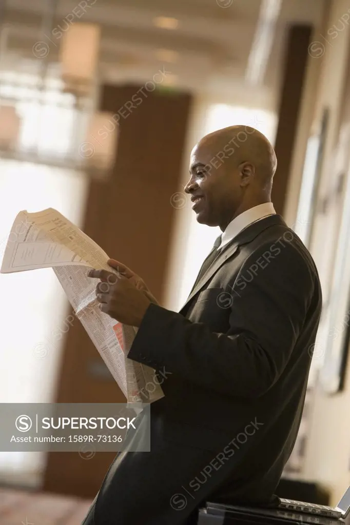 African businessman reading newspaper