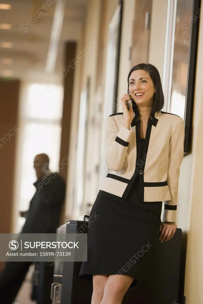 Mixed race businesswoman talking on cell phone