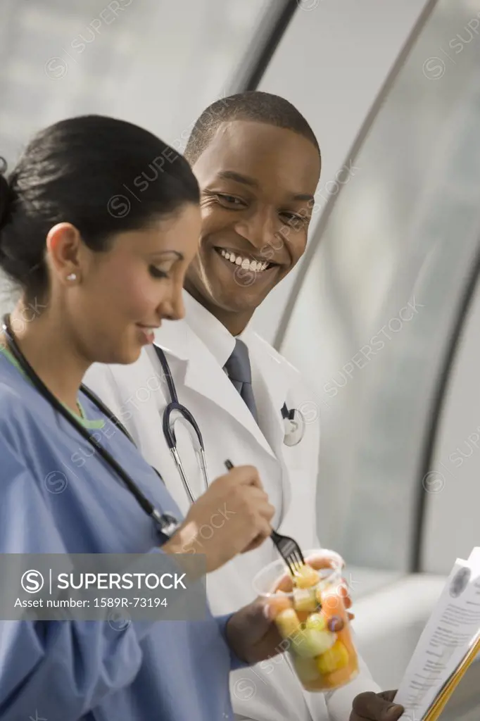 Doctor and nurse eating fruit