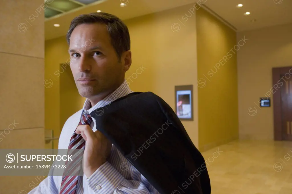 Businessman holding suit jacket over shoulder