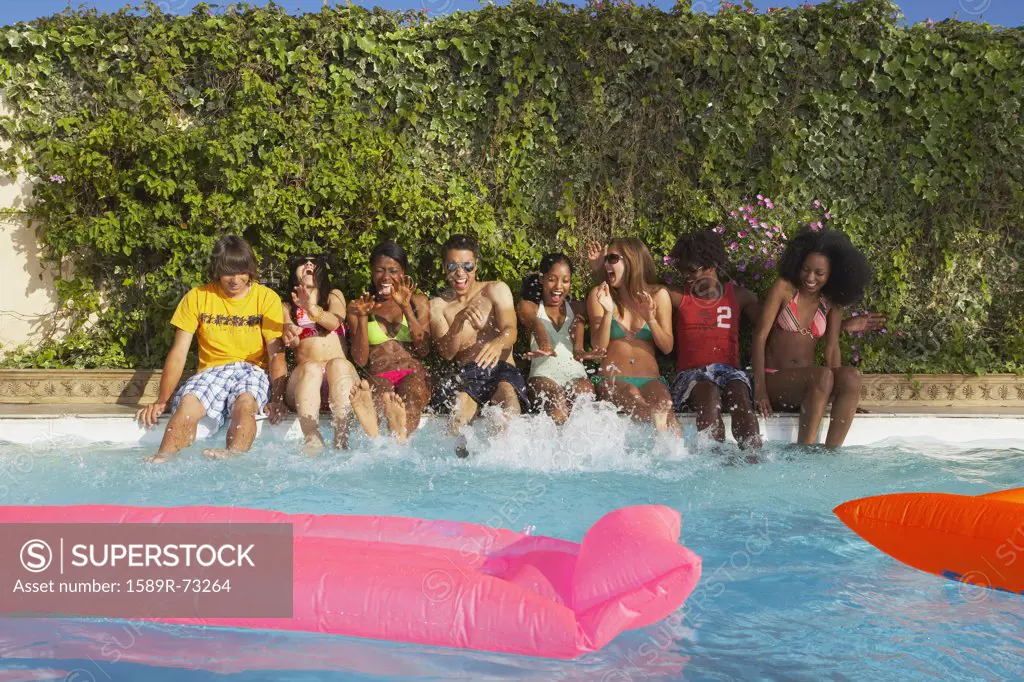 Multi-ethnic group of friends enjoying pool party