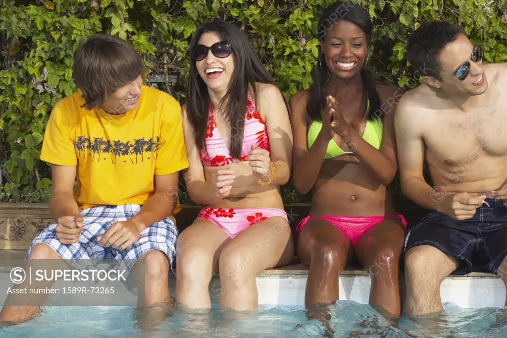 Multi-ethnic group of friends enjoying pool party
