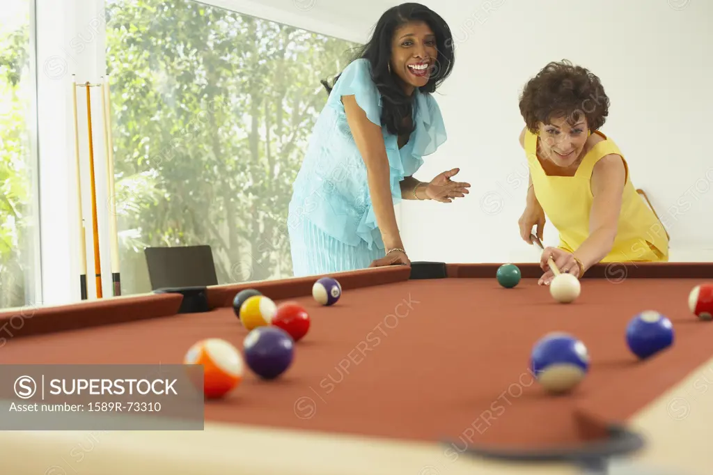 Multi-ethnic friends playing pool