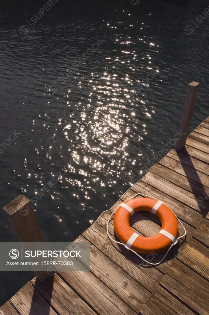 Round life preserver on wooden dock