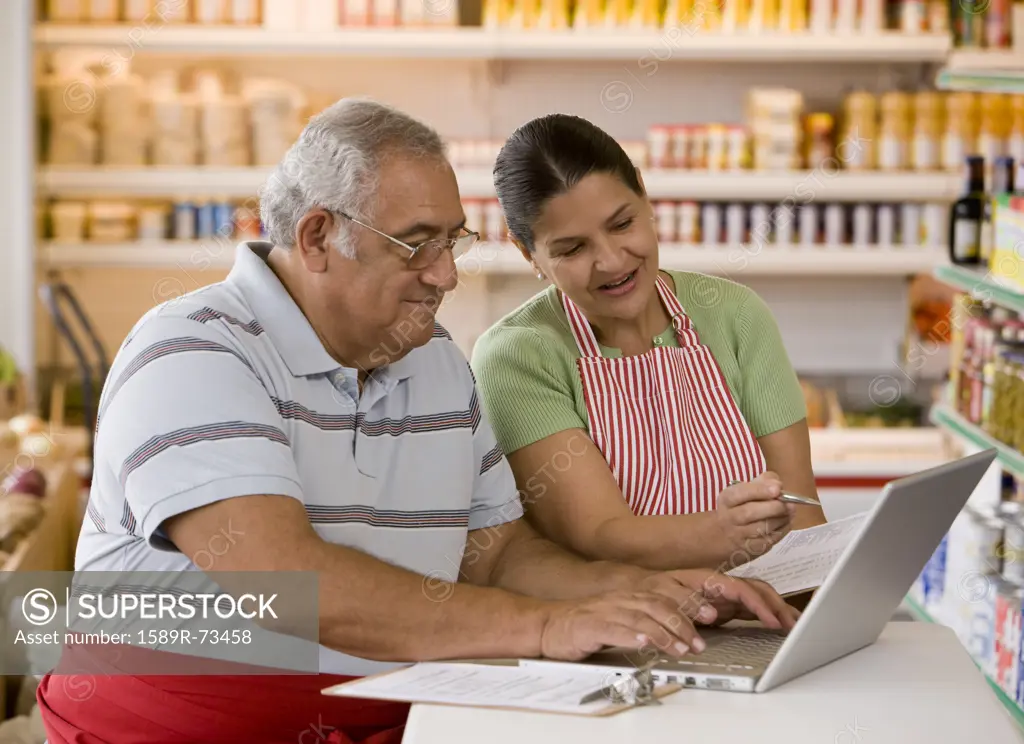 Hispanic business owners using laptop