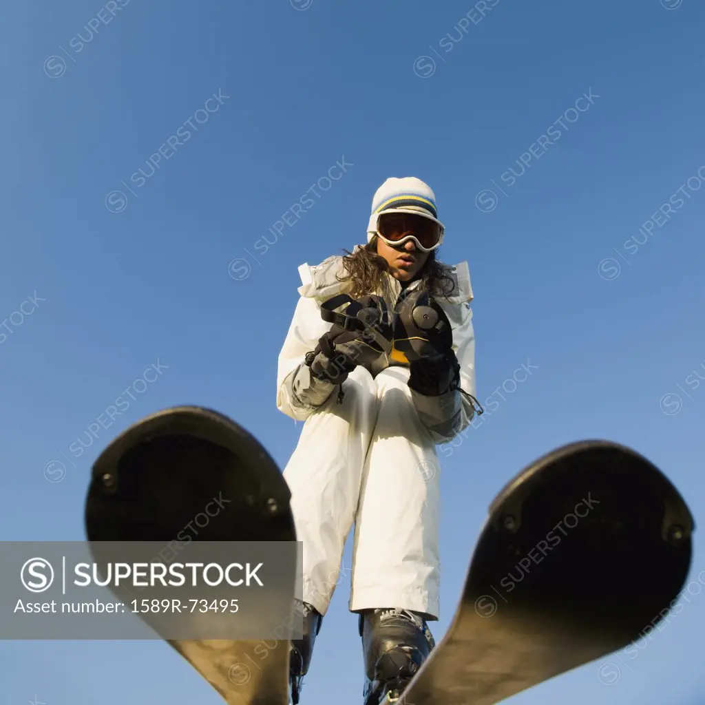 Mixed race woman skiing