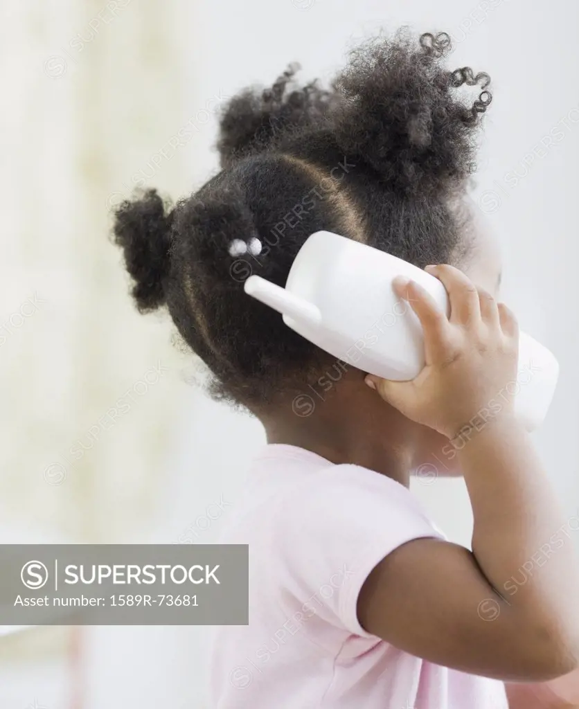African American girl playing with toy phone