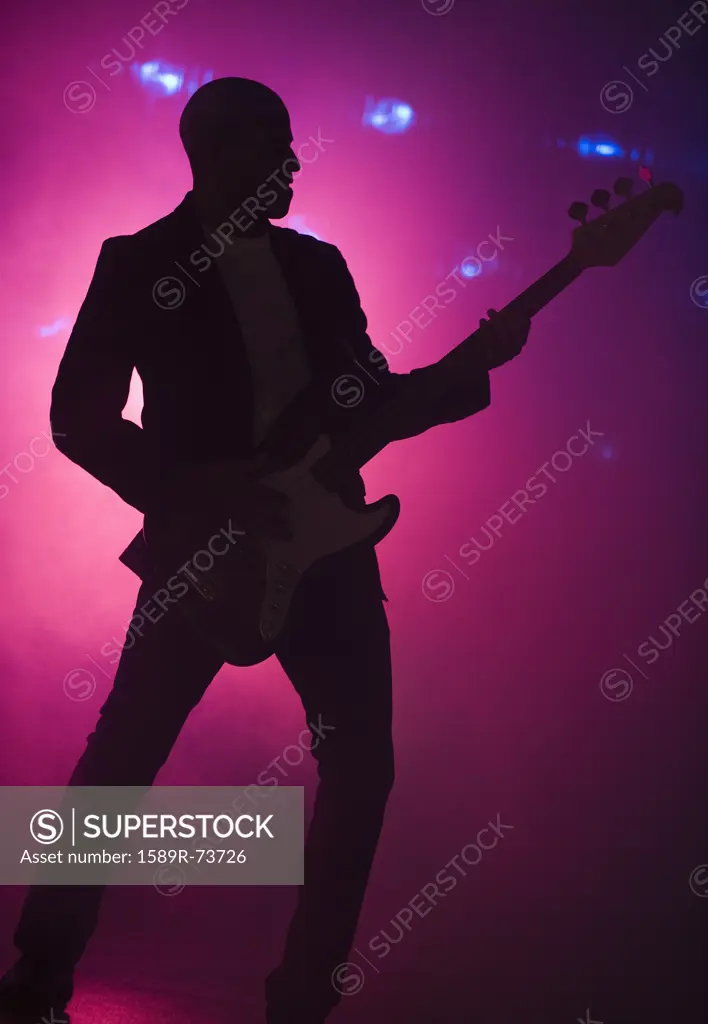 African American man playing guitar at nightclub