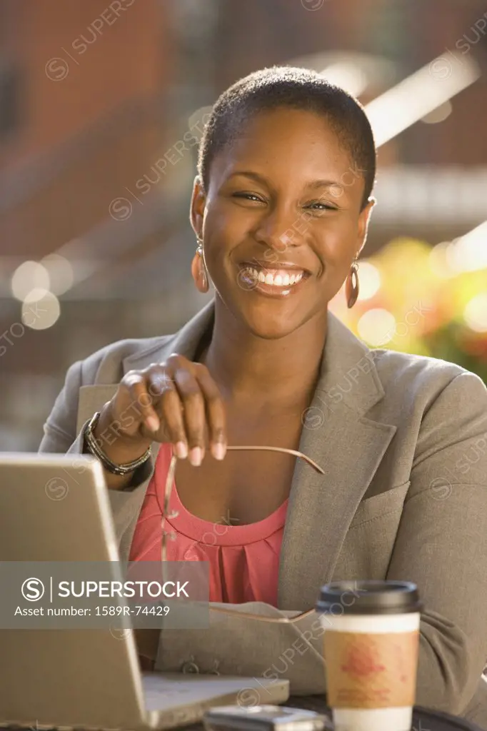Smiling African businesswoman working outdoors