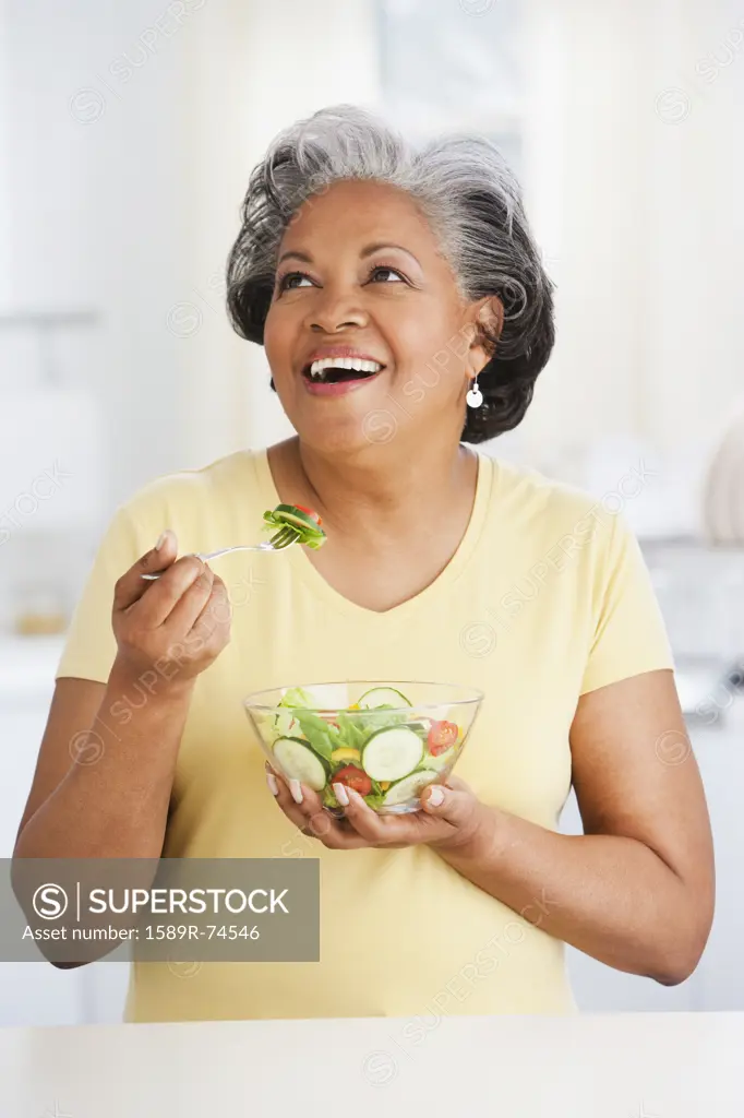 African woman eating healthy salad