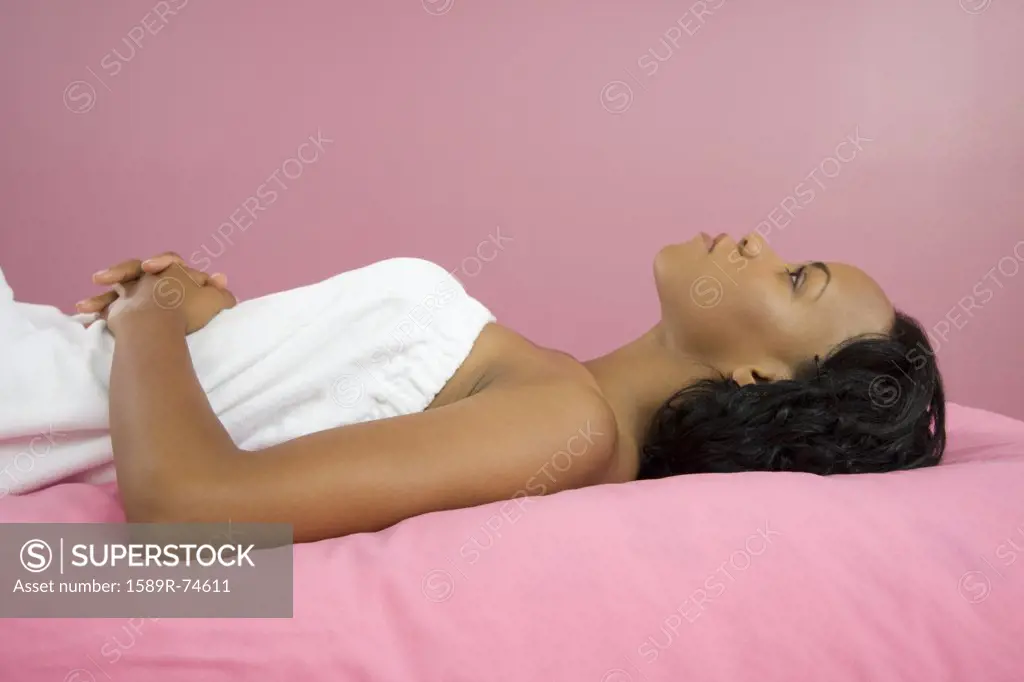 African American woman laying on massage table