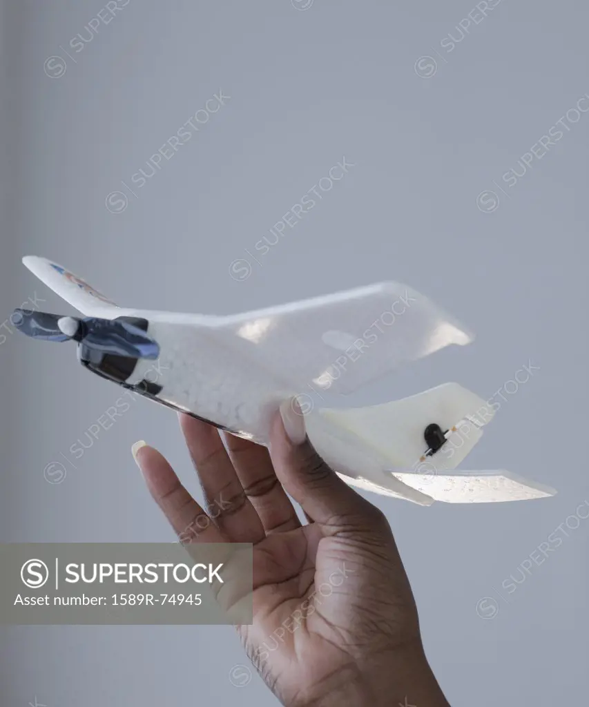 African woman holding airplane model