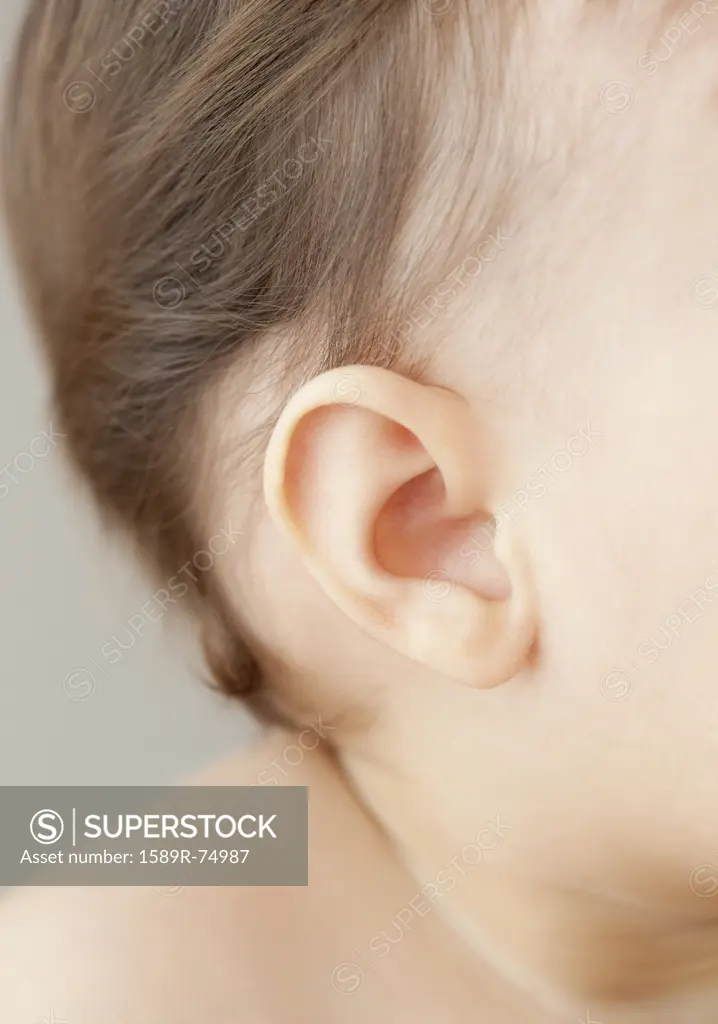 Close up of mixed race baby girls ear