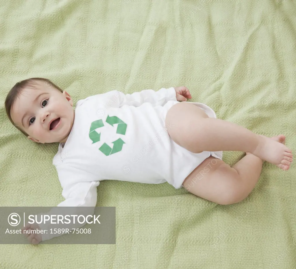 Mixed race baby girl with recycling symbol on shirt