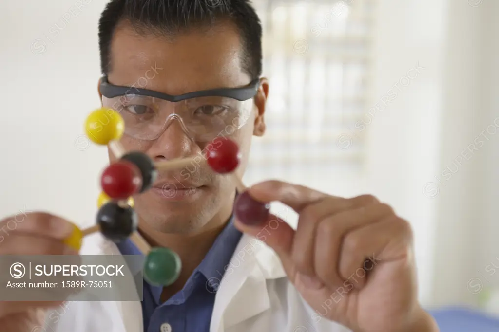 Asian scientist with molecule model