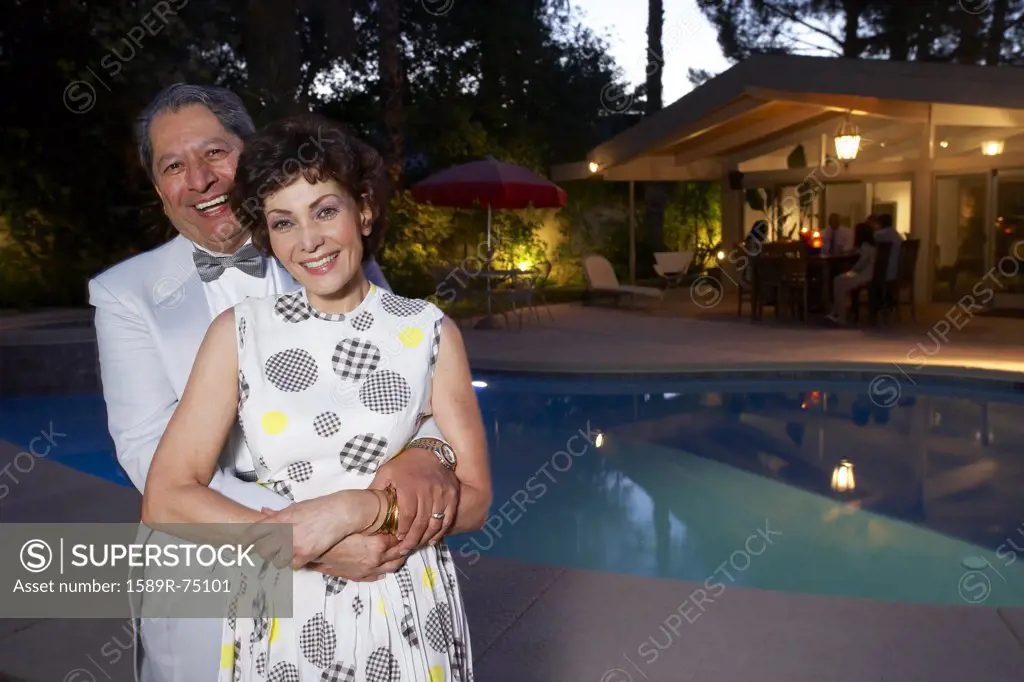 Multi-ethnic couple enjoying pool party