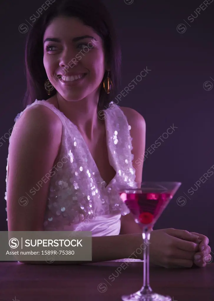 Hispanic woman drinking cocktails