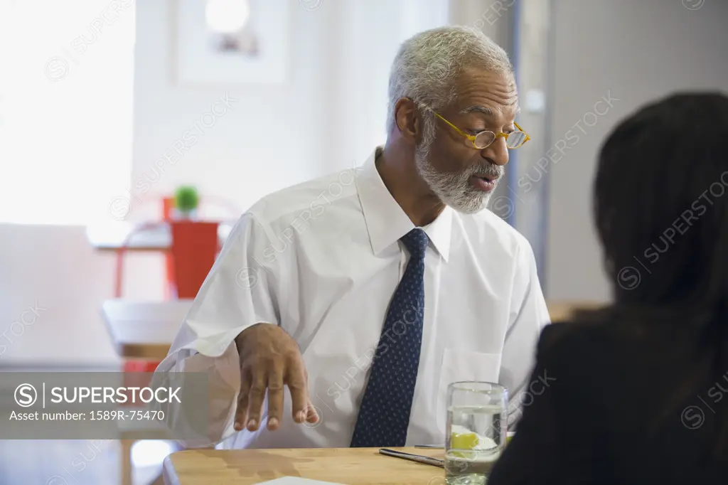 African man having lunch with co-worker