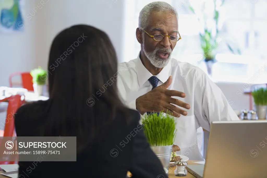 African businessman having lunch with co-worker