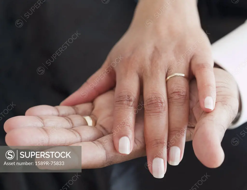 Close up of African couple holding hands