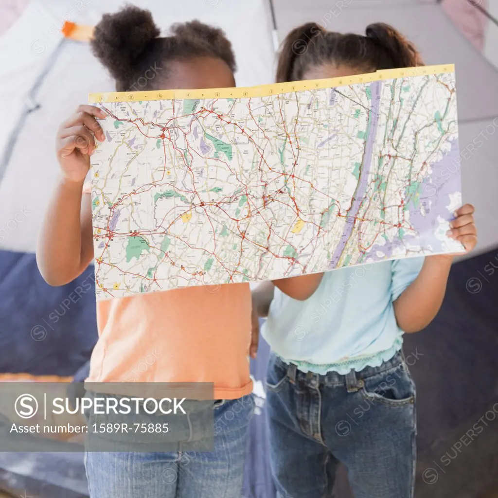 African girls looking at map