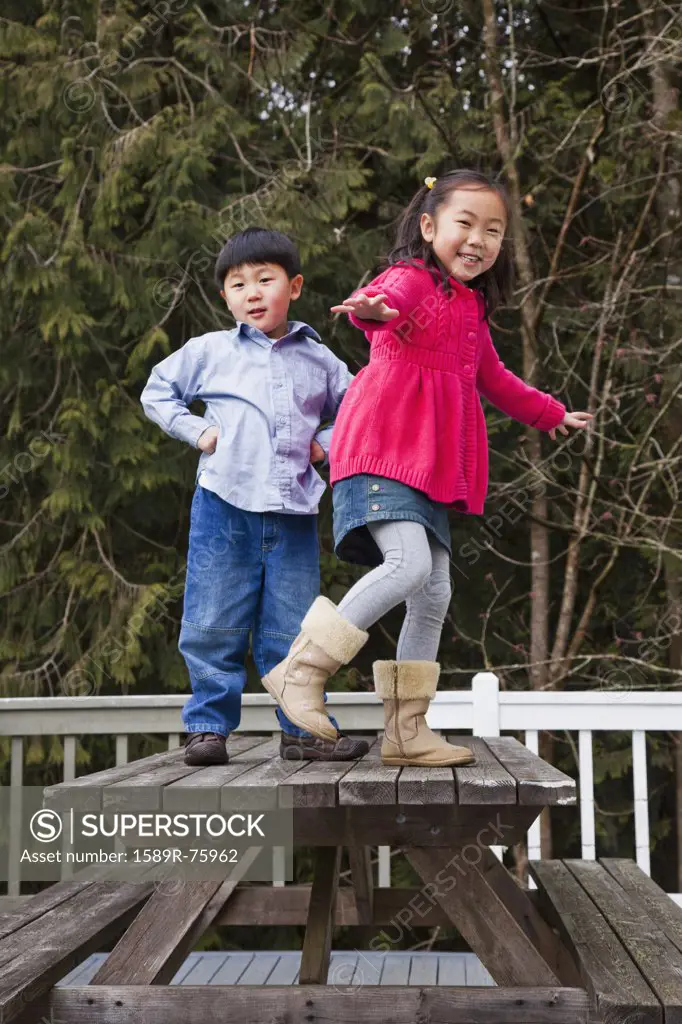 Korean children playing on picnic bench